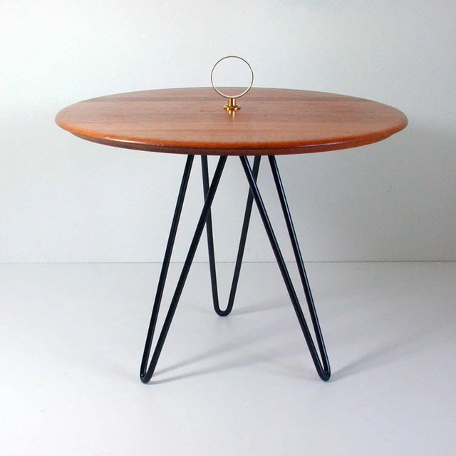 This round vintage tripod side table was made in Denmark in the 1950s to 1960s by Digsmed. It has a black lacquered cast...