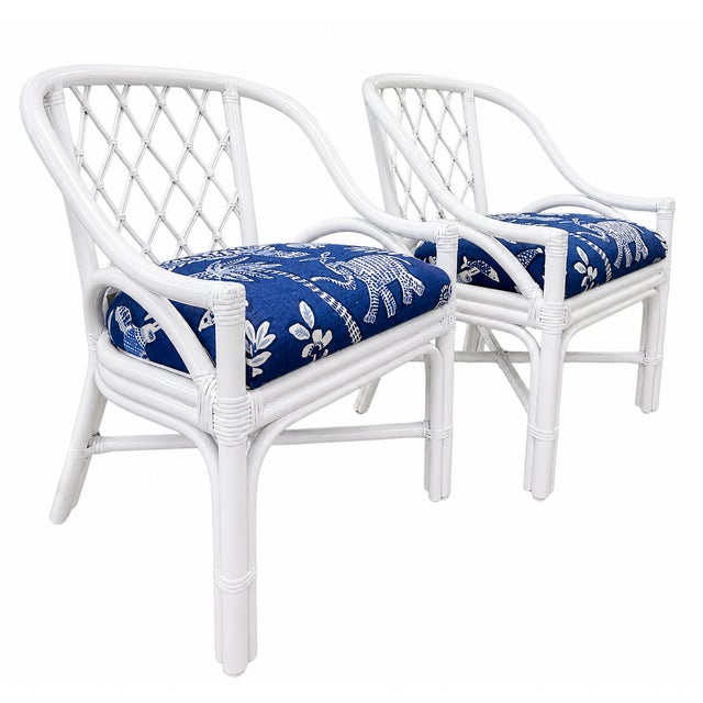 A stylish pair of vintage diamond-back rattan armchairs professionally refinished in a fresh high-gloss white lacquer....