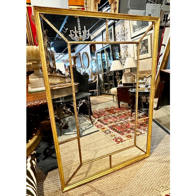 This is a large over-mantle mirror that dates to the early 19th century. This uncommon form of mirror features a carved...