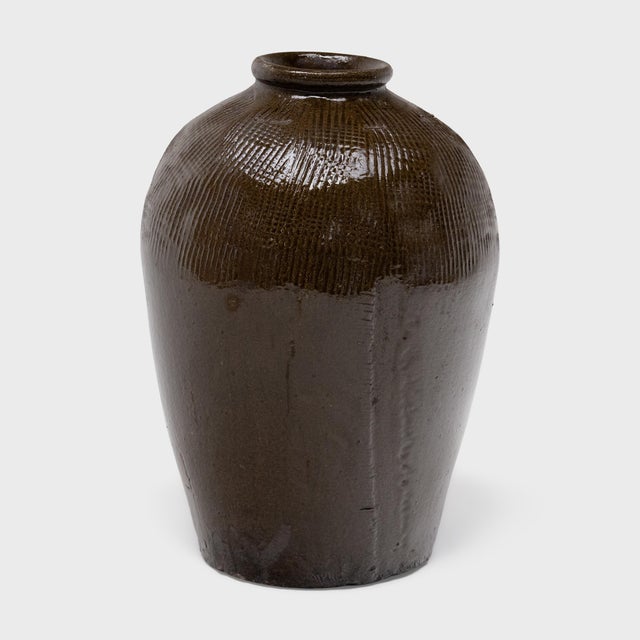 This large ceramic jar is a vintage Chinese wine vessel from the early 20th century, originally used for aging wine and...