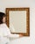 This piece presents as a mirror, distinguished by gold ornate textured frame, rectangular. Dating to 1900s and originating...