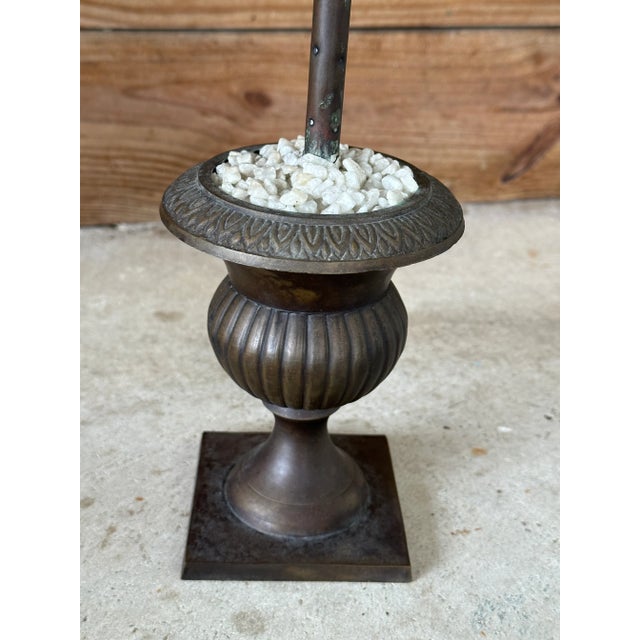 A wonderfully sculptural vintage metal palm tree rising from a classical urn-form base. Layers of individually formed palm...
