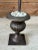 A wonderfully sculptural vintage metal palm tree rising from a classical urn-form base. Layers of individually formed palm...