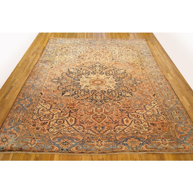 Vintage Persian Heriz Oriental rug, Large size. A vintage Persian Heriz oriental rug, size 14'8" x 11'2", circa 1930. This...