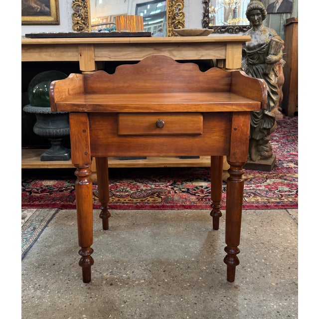 Handmade early American side table or washstand featuring a single drawer, pegged construction, square nails, and turned...