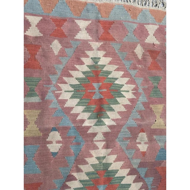 Nice vintage Turkish Anatolian Kilim with beautiful tribal and geometrical design and nice colours with a purple field,...