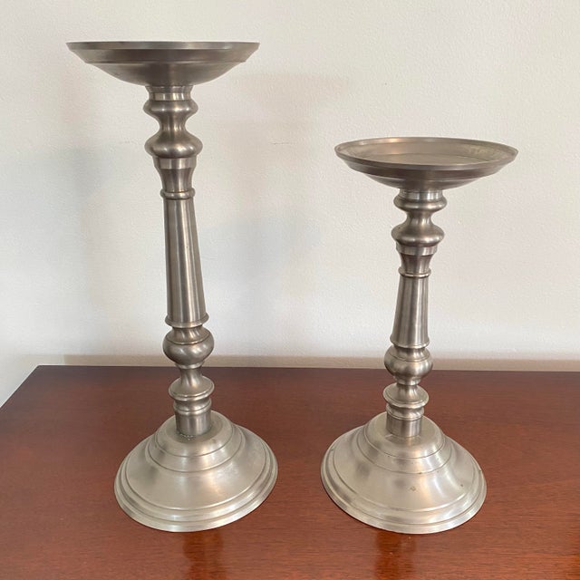 Fabulous set of two substantial candle holders made by Eddie Bauer. Brass base with silver pewter finish. 17”H x 6”W x 7”...