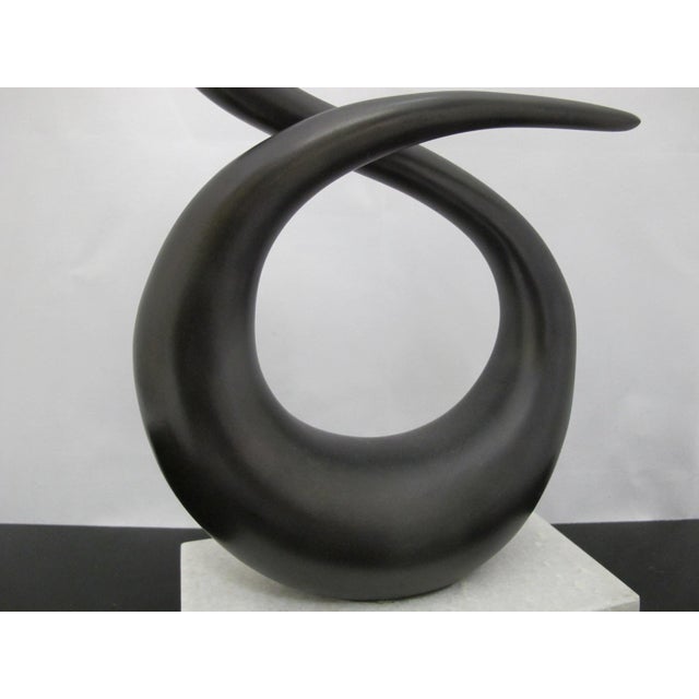 Interlude Home modernist style sculpture. Twisted metal sculpture on attached to white marble base. Base stickers "India...