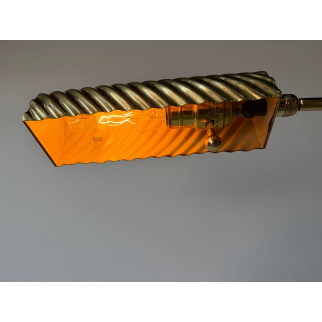 A sleek 1970s Mid-Century Modern solid brass pharmacy floor lamp featuring a distinctive fluted brass shade and clean...
