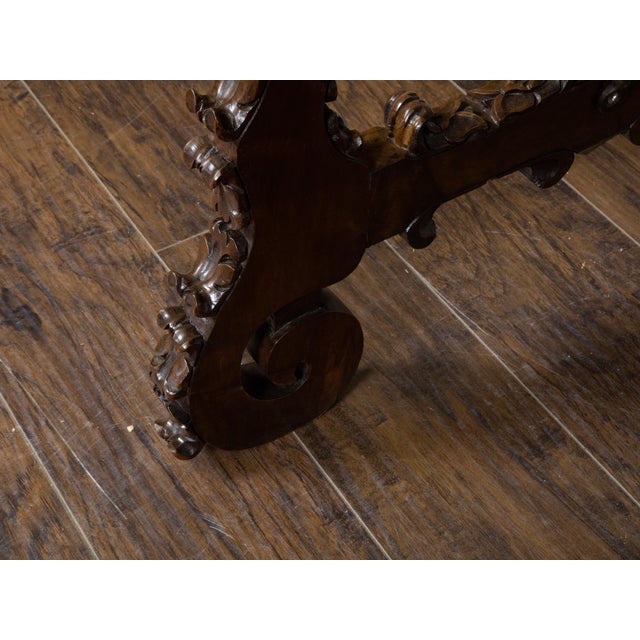 An Italian Baroque style walnut Fratino console table from the 19th century, with carved lyre-shaped trestle base,...