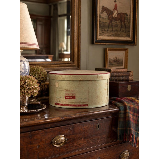 This vintage Penney’s Marathon men’s hat box dates to circa 1950s. The oval box is covered in muted pale green paper with...