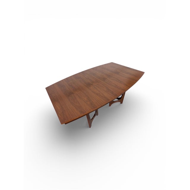 Elevate your dining space with this striking Mid-Century Modern walnut dining table by Young Manufacturing. Known for...