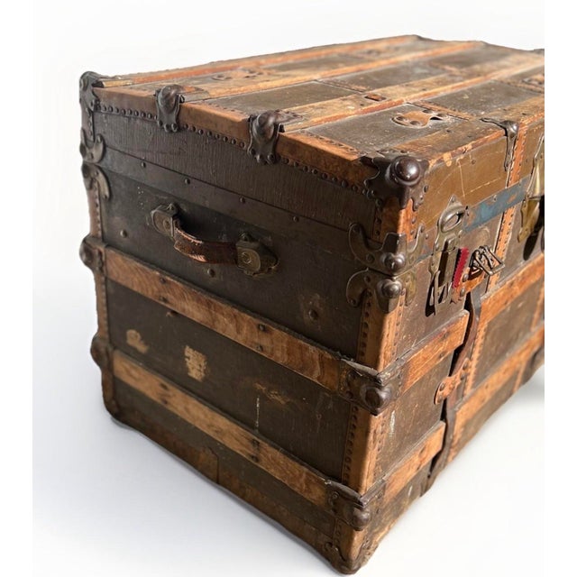 Chairish Description: Antique European travel trunk from the early 1900s featuring a beautifully aged brown exterior with...