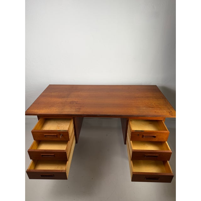 Original Danish teak desk from the 1960s, designed in the characteristic Scandinavian Modern aesthetic. The clean,...