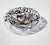 This thick-walled bowl-shaped object, in the primary colors red yellow and blue, was made in memory of Jackson Pollock who...