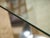 Dramatic sculptural dining table combining a substantial oval glass top with an architectural chrome base and cylindrical...