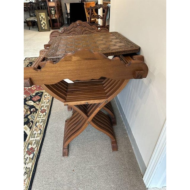 Beautiful and very unique original wood carved game table and two folding chairs. The intricate carvings are beautiful and...