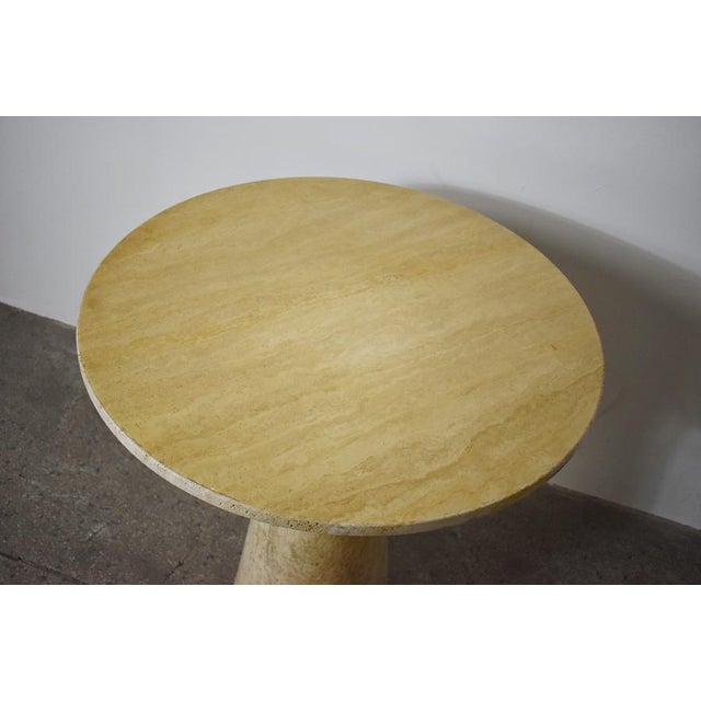 Solid travertine table. Has some usage marks due to age and use.