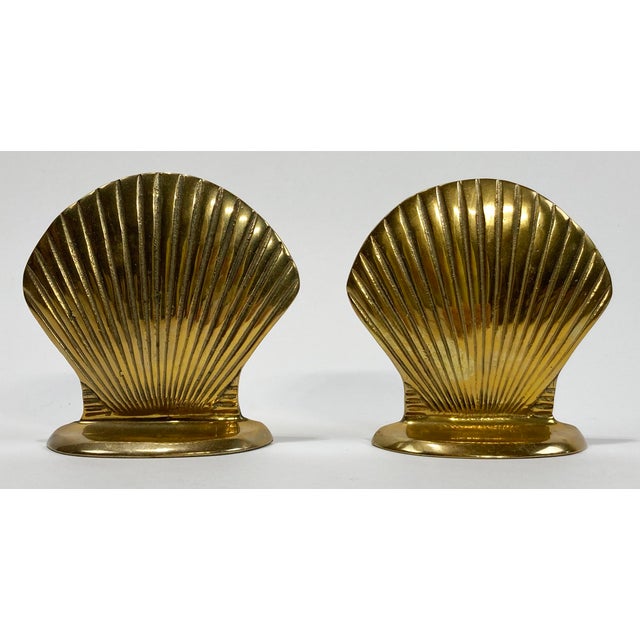 Vintage pair of brass bookends with clam shell motif. Lovely patina.