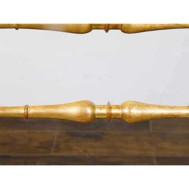 A pair of Italian Midcentury gilt wood high back side chairs with spindle motifs and new custom upholstery. This...