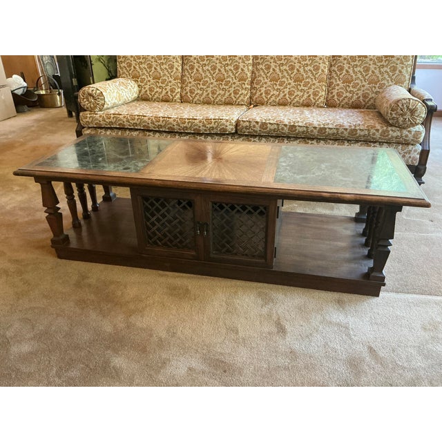 This elegant table is a striking piece that combines natural wood and marble, featuring a mid-century modern aesthetic....