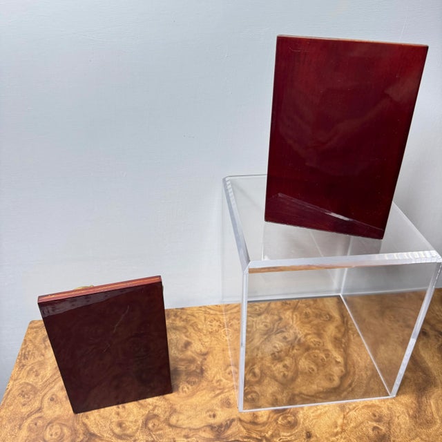 A pair of brass anchors on wooden base bookends in decent condition. There is a missing gold strip on one of the bookends....