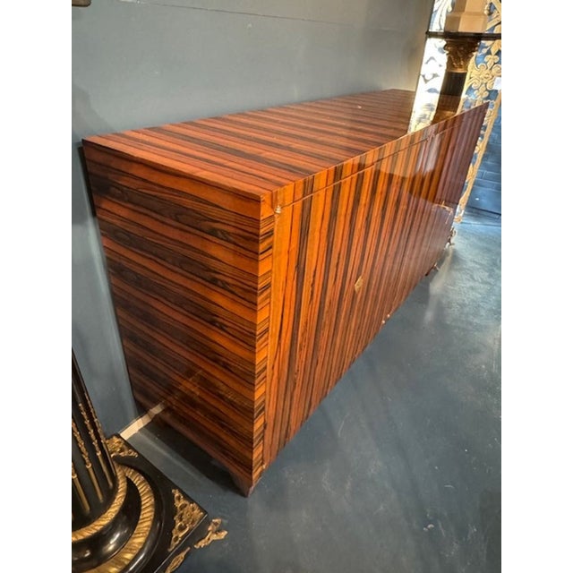 The Italian Art Deco Macassar Ebony Sideboard is a beautifully crafted piece of furniture that exudes sophistication and...