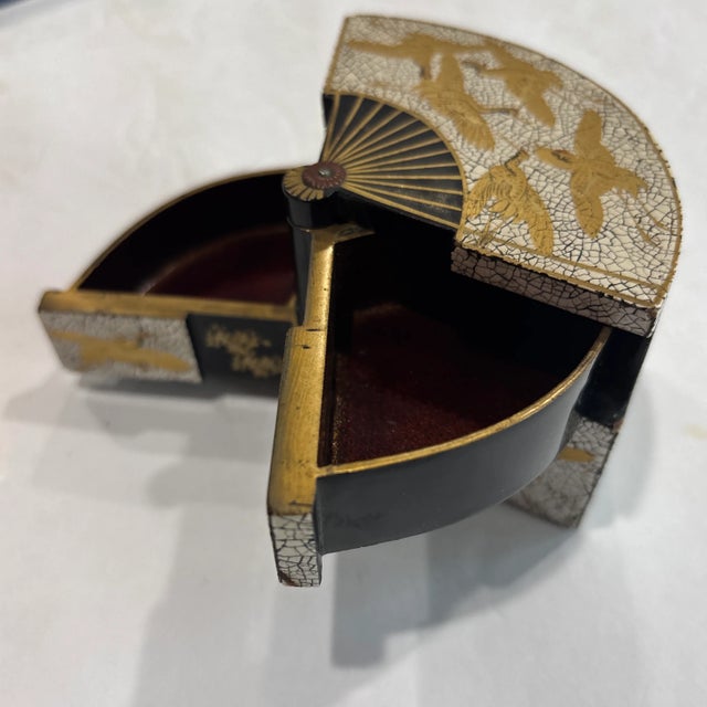 Japanese Meiji era (1868-1912) Fan-Shaped Lacquer Box with black and gold takamaki lacquer cranes on a Rankaku (eggshell...
