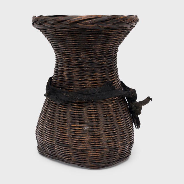 Woven with precious scale and delicate artistry, this petite bamboo basket from the early 20th century is a beautiful...
