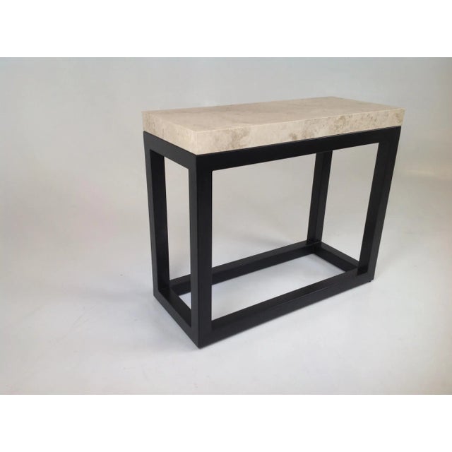 Modern console table with travertine top. Table is made of iron. The travertine is honed ‘filled. The base has a copper...