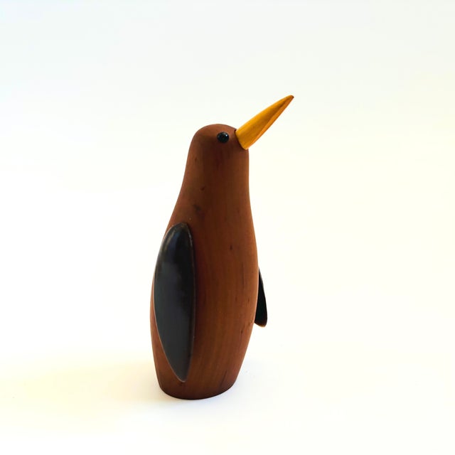 A mid century turned wood figurine in the shape of a Penguin. Adorable stylized features. Wings are made of plastic. Made...