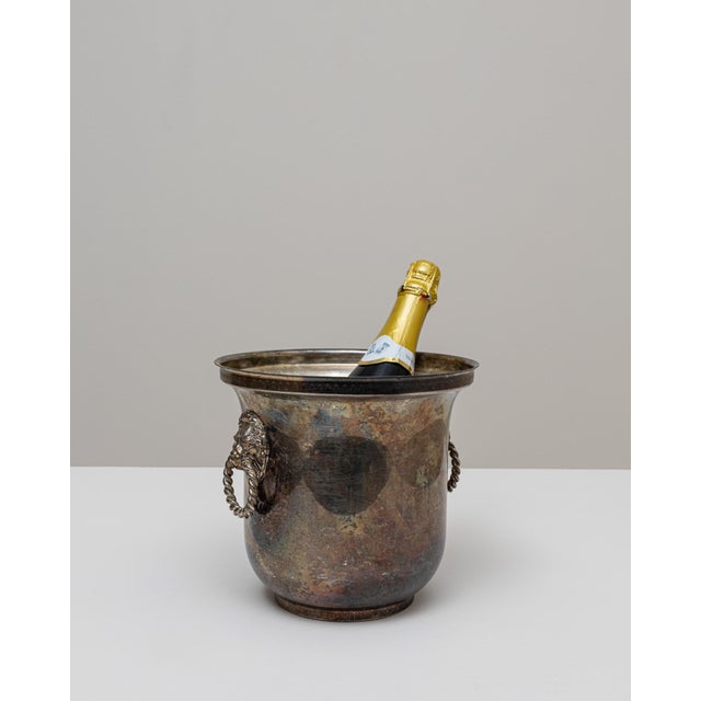 A 20th Century French silver-plated champagne bucket with a richly aged surface that highlights its decades of use and...