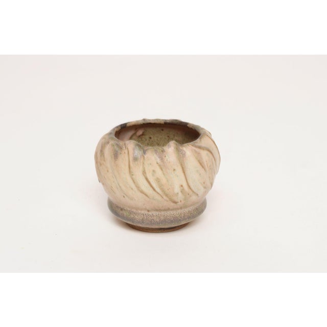 Studio ceramic variegated bud vase with drainage hole by ceramicist, Deanna Nichols (b. 1942-2017, Missouri). Holding a...