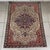 A precious and charming vintage rug with a light background, attributed to the renowned 19th-century Persian Sarouk...
