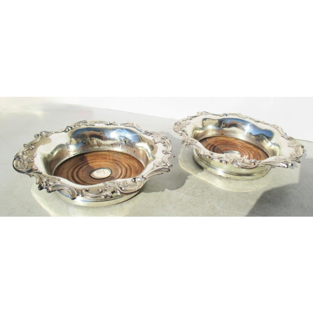 Antique late 19th century pair of two wine caddies for the table. Silver plate with wooden base plates to hold moisture...