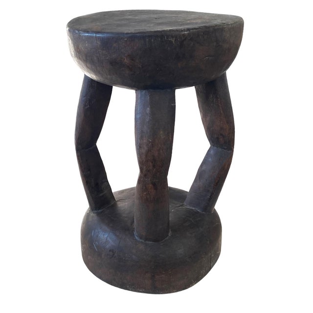 Hand-carved from a single wood block, this vintage milk stool features four curved legs and an 8.5" diameter seat at...