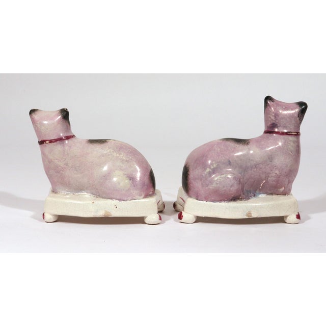 Staffordshire Pottery Cats on Cushions, Pair of Lilac Recumbent Figures Circa 1820–1840 This pair of Staffordshire pottery...