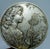 French commemorative Larousse medallion depicting an Art Nouveau-inspired allegorical female figure releasing dandelion...