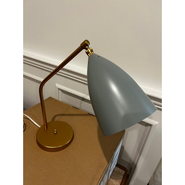 The Gräshoppa table lamp, originally designed by Greta Magnusson Grossman in 1947 and reissued by GUBI, is a mid-century...