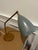 The Gräshoppa table lamp, originally designed by Greta Magnusson Grossman in 1947 and reissued by GUBI, is a mid-century...