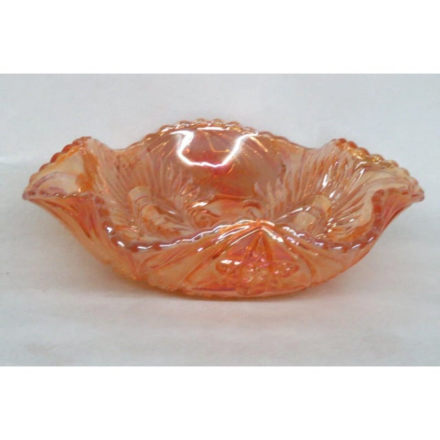 This lovely bowl is made of carnival glass. This bowl features the "Curved Star" pattern to the exterior and "Headdress"...