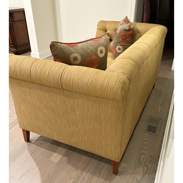 Chesterfield-style sofa with a contemporary update, suitable for modern decor preferences. It features classic deep...