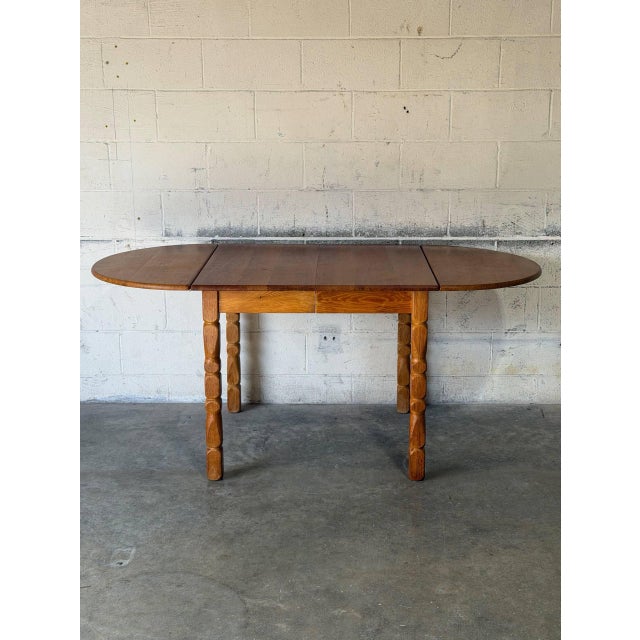 This versatile oak dining table features convenient pull-out leaves and sculptural turned legs for classic Scandinavian...
