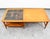 Heritage Tile walnut coffee table with cane shelf beneath. Signed example.