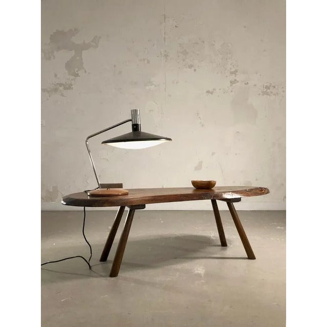 An adjustable, modernist, Bauhaus, constructivist, libre-shaped table lamp, a circular-shaped circular base in brown wood,...