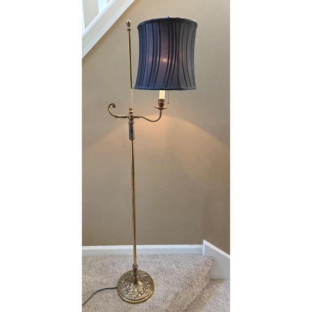 Beautiful deco details on the vintage brass floor lamp. The base is embossed with a lovely floral, vine patter. A black...