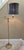 Beautiful deco details on the vintage brass floor lamp. The base is embossed with a lovely floral, vine patter. A black...
