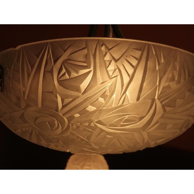 This large pending light with a geometric motive was produced by famous “Noverdy” company in France in the 1920s. Its...