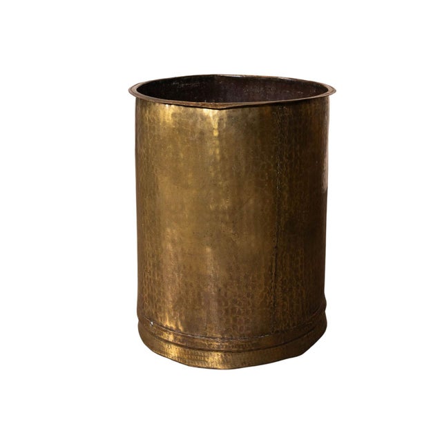 Brass pot with shaped lip. Textured surface.