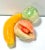 A charming set of hand-carved stone fruit sculptures including a banana, peach, and pear. Each piece is carved from...